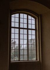 A large window behind which it is raining