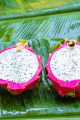 Ripe dragon fruit on a wet green leaf. Vitamins, fruits, healthy foods