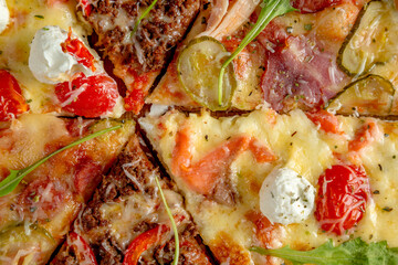 Assorted several types of pizza. Black background.