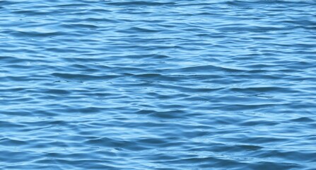 Naklejka premium Natural light blue water surface with soft waves as a background