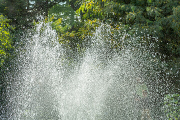 Small fountain in a city public park in the summer sunny day