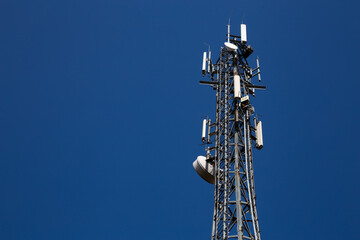 Mast of the cellular  network over the blue sky