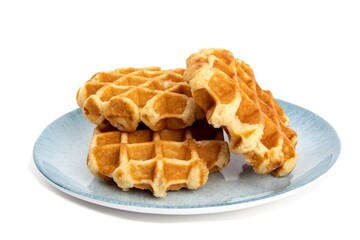 a pile of Belgian waffles on a blue plate isolated on white