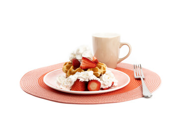 Belgian waffles with strawberries and whipped cream and a coffee cup isolated on white