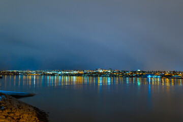 Night photo of Reykjavik city beach. Waterfront lights