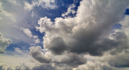 Fototapeta na wymiar large clouds in dark blue sky