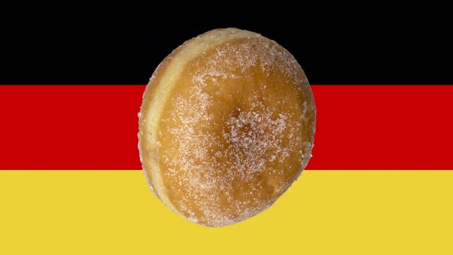 German donut appears on top of a German flag and then spins around 360 degrees
