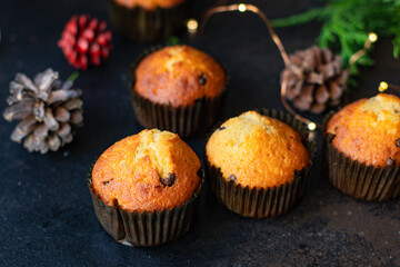 muffins cupcakes chocolate drops
homemade baking cakes on the table christmas lights new year treat tasty serving size top view copy space for text food background rustic