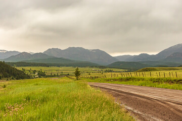 dirt road going towards the mountains in Colorado 