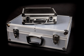 a small and a large equipment travel cases isolated on black
