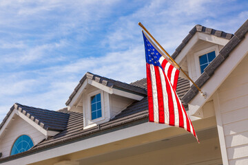 American Flag Hanging From House Facade