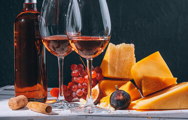 set of different types of cheese. romantic dinner for two. cheese fruit and two glasses of wine