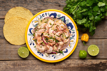 Mexican shrimp raw aguachile on wooden background