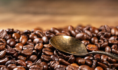 Freshly roasted coffee beans and spoon.