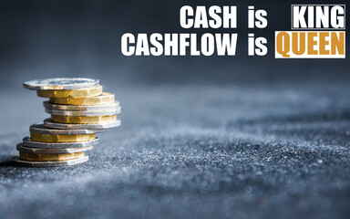 Cash is king, cashflow is queen phrase on a dark background with money, coins on a side