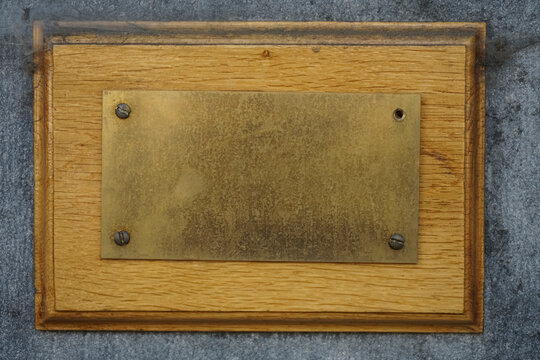 Old yellow iron empty mockup blank layot on a grunge stone wall. brown wooden board background. empty copy space for inscription. bolted nameboard.
