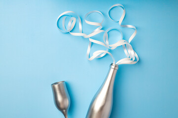 Champagne bottle with streamers flat lay top view