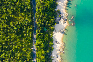 High angle view of  road pass through coconut tree forest and beautiful coastline in Khanom, Nakhon si thammarat, Thailand.