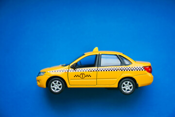 yellow taxi car on blue background.Taxi service concept.