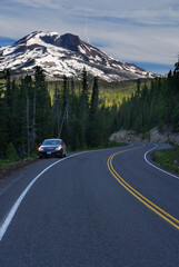 Naklejka premium Car stopped on shoulder of Cascade Lakes Highway with South Sister Mountain