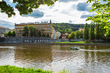 Fototapeta na wymiar Prague architecture. Embankment in a green park.