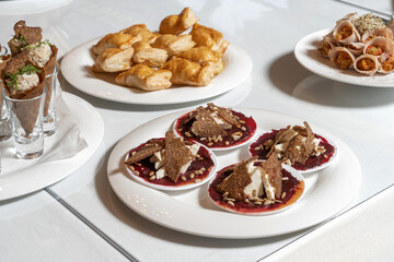 Luxurious catering table. Croutons with cheese and jam, decorated with seeds.