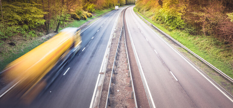 Speeding blurred truck on a dual motorway in Scotland - speeding drivers of lorries are dangerous