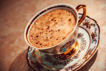 beautiful gold Cup of Cappuccino Coffee on the table