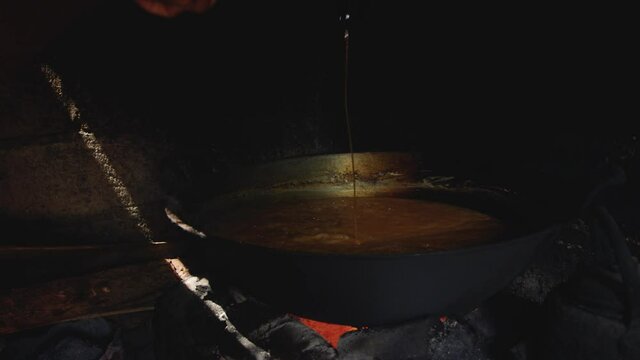 Stirring coconut nectar or neera to make solid organic coconut sugar
