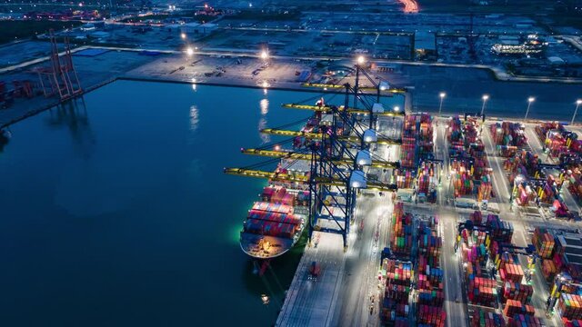 Time lapse Container , container ship in export and import business and logistics. Shipping cargo to harbor by crane. Water transport International. Aerial view and top view.