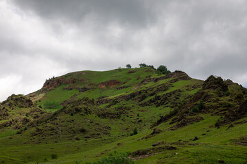 Obraz premium Mountain landscape with blue sky. Panoramic view of green hills. 