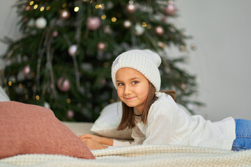 Happy childhood, Christmas magic fairy tale. Little girl waiting for Christmas and holiday gifts.