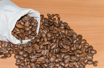 roasted coffee beans, in a bag on a wooden table