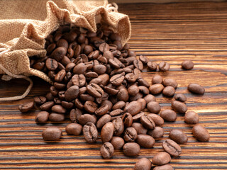 Coffee beans in sack Coffee on an old wooden texture background with space for text