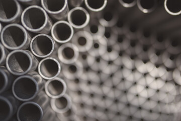 A group of metal pipes together. Top view, shallow depth of field.