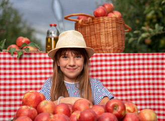 Beautiful Blue Eyed Girl in Hat With Freshly Harvested Red Apples - Healthy Food Concept
