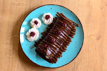 chocolate pancake with bananas, nuts and chocolate sauce. the toning. selective focus. 
a rolled chocolate pancake is a calorie bomb
