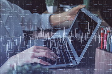 Double exposure of woman hands typing on computer and forex chart hologram drawing. Stock market invest concept.