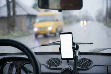 Smartphone in car. Driving a car with smartphone in holder. Mobile phone with isolated white...