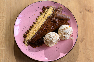 pancake topped with chocolate with 
a beautifully decorated caloric pancake full of delicious chocolate.
pancake on a different plate with many different chocolate toppings.
a calorie bomb called love