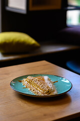 a beautifully decorated caloric pancake full of chocolate.
pancake on a blue plate with many different chocolate toppings.