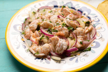 Mexican shrimp raw aguachile on turquoise background