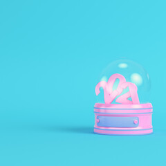 Pink snow globe with 2021 figures on bright blue background in pastel colors