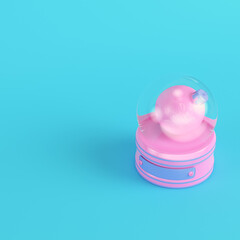 Pink snow globe with christmas bauble on bright blue background in pastel colors