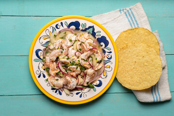 Mexican shrimp raw aguachile on turquoise background