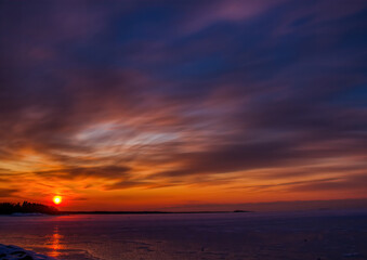 Obraz premium Pictures of a sunset on the frozen Baltic Sea near the Finnish town of Rauma