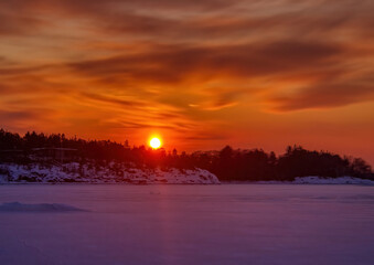 Pictures of a sunset on the frozen Baltic Sea near the Finnish town of Rauma