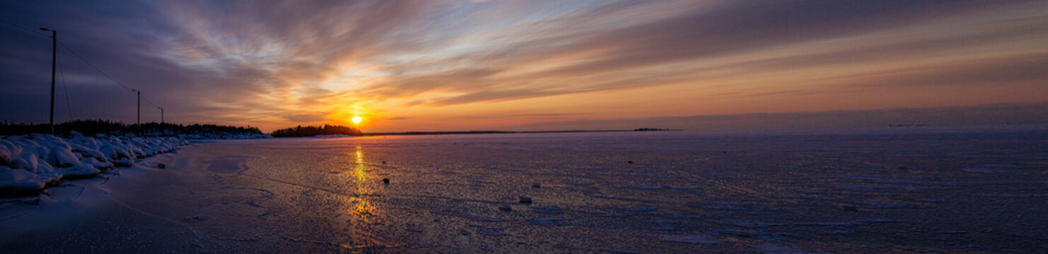 Pictures of a sunset on the frozen Baltic Sea near the Finnish town of Rauma