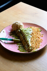 
caloric pancakes with green topping and hazelnuts. beautifully decorated pancakes with a scoop of ice cream