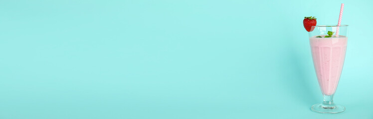 Tasty fresh milk shake with strawberry on light blue background. Space for text